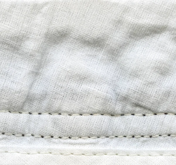 crumpled white textile background,stitches