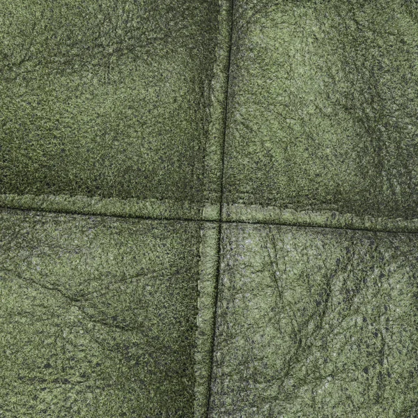 Fundo de couro verde decorado com costuras — Fotografia de Stock
