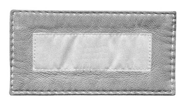 Tom grått skinn och vit textil etikett isolerad på vit — Stockfoto