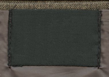 kahverengi Tekstil zemin üzerine boş siyah kumaş etiket