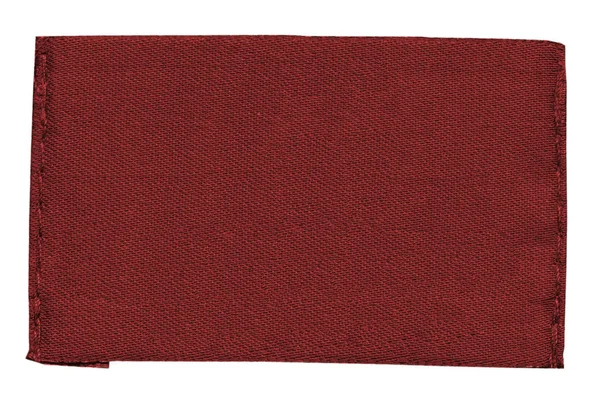Etiqueta de tecido vermelho em branco isolada no fundo branco — Fotografia de Stock