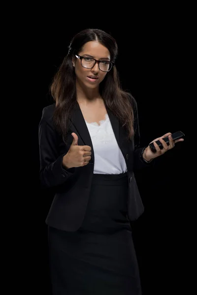 Business woman with thumb up and smartphone — стоковое фото