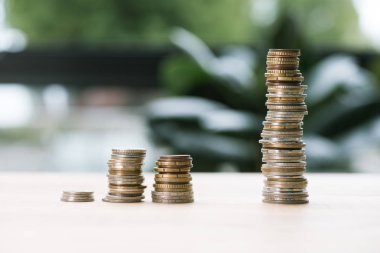 stacks of coins on table clipart