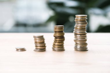 stacks of coins on table clipart