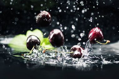ripe cherries falling in water clipart