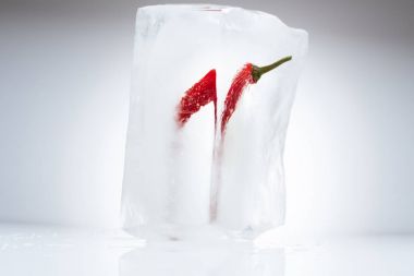 chili pepper in melting ice clipart