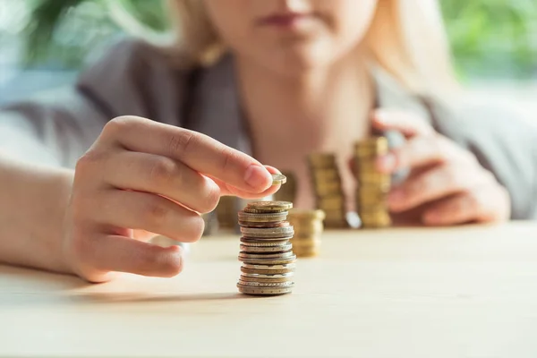 Woman stacking coins — Stock Photo, Image