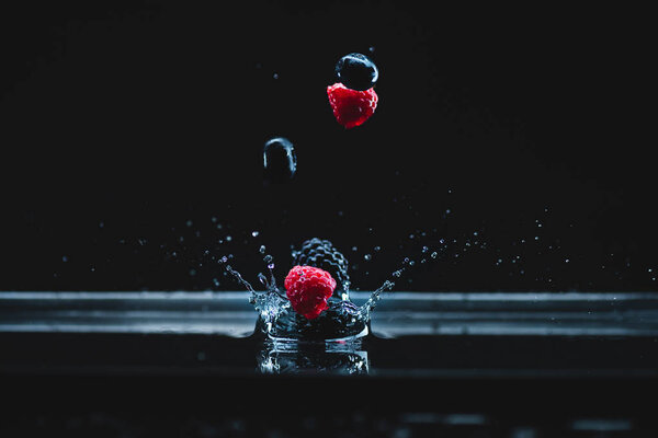 ripe berries falling in water