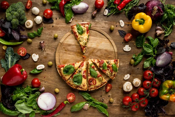 Pizza slices on wooden board — Stock Photo, Image