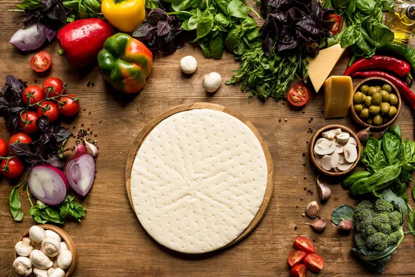 Raw pizza dough and ingredients — Stock Photo, Image