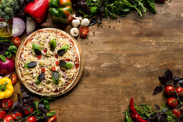 raw homemade pizza with ingredients