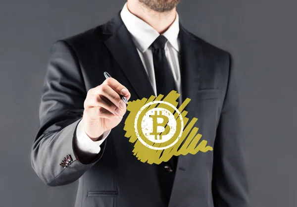 Businessman drawing bitcoin sign — Stock Photo, Image