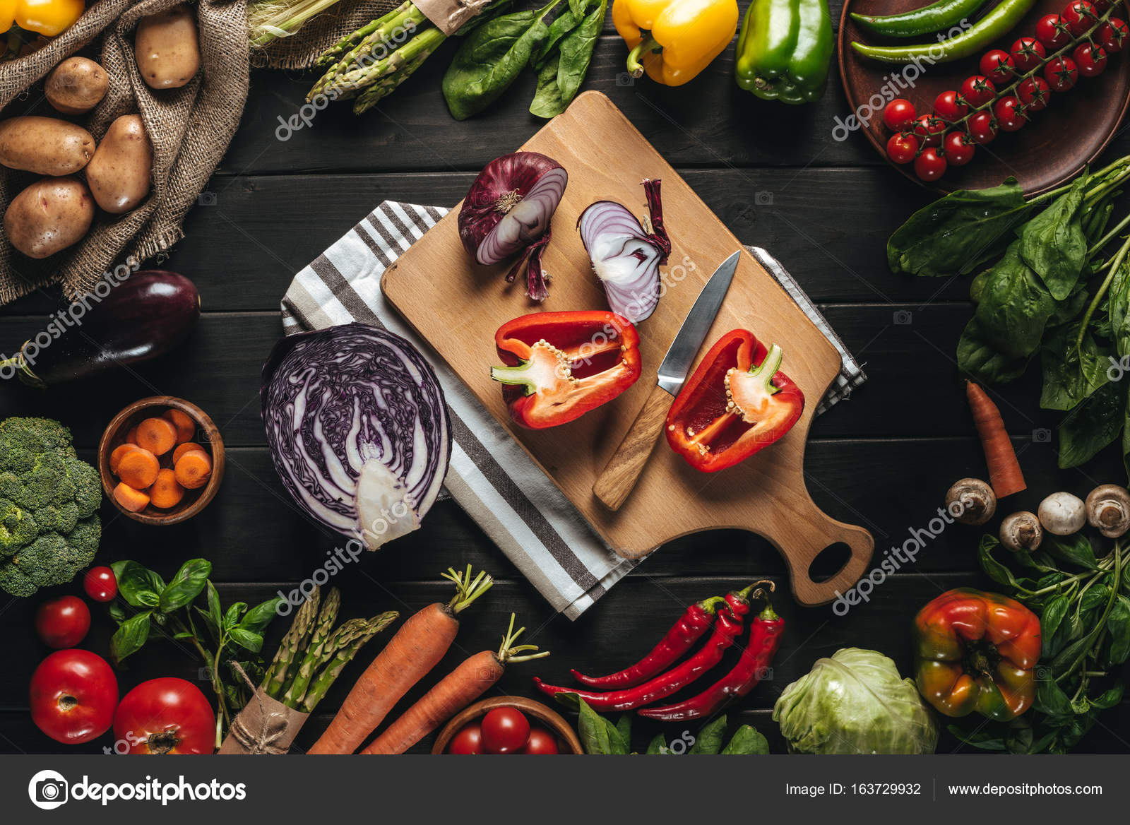Fresh vegetables on woden cutting board with knife