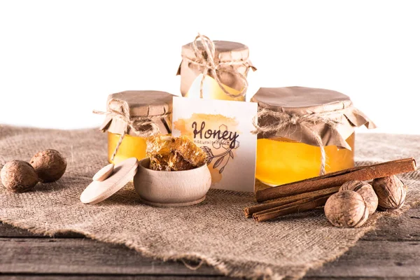 Honey in glass jars and card — Stock Photo, Image