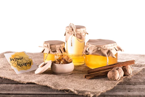 Honey in glass jars and card — Stock Photo, Image