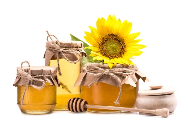 Sunflower and honey in glass jars — Stock Photo, Image