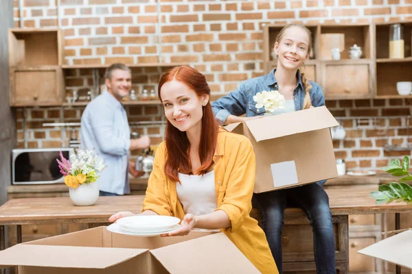 Family unpacking cardboard boxes — Stock Photo, Image