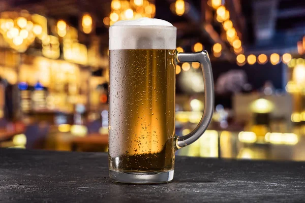 Mug of beer on table — Stock Photo, Image