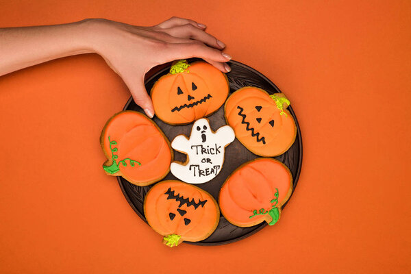 woman taking halloween cookie