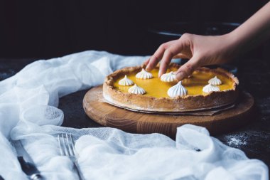 female hand placing meringue onto pie clipart