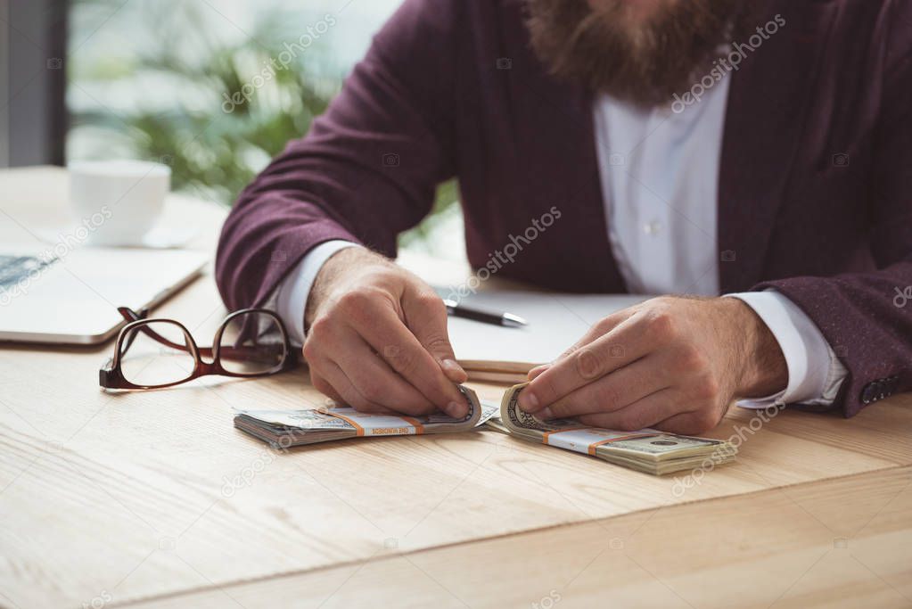 businessman counting dollars