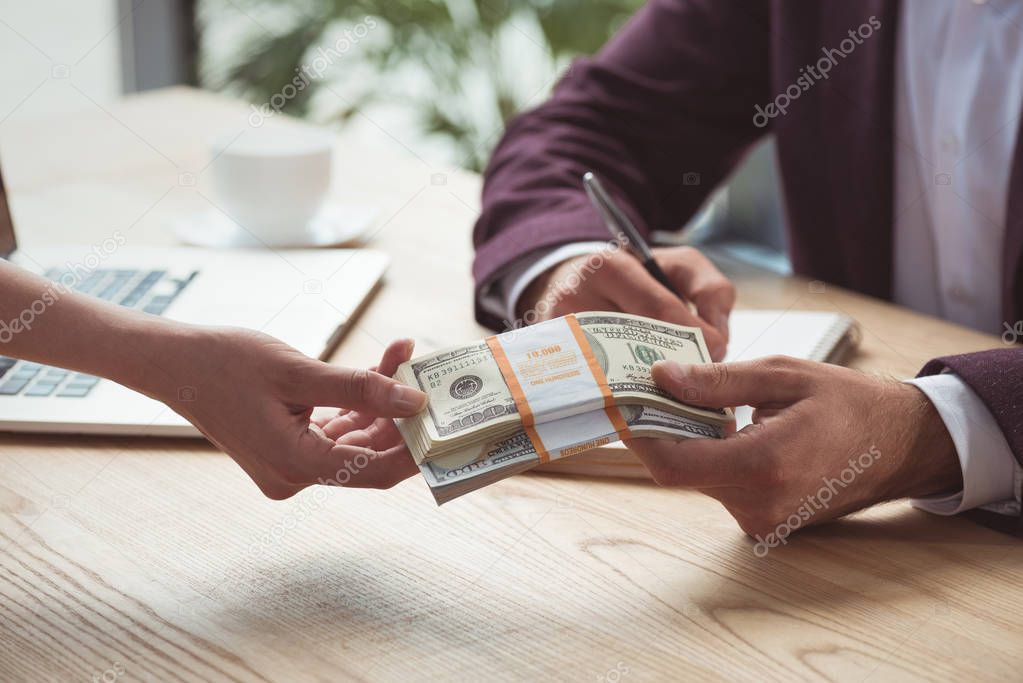 businesspeople with dollar banknotes