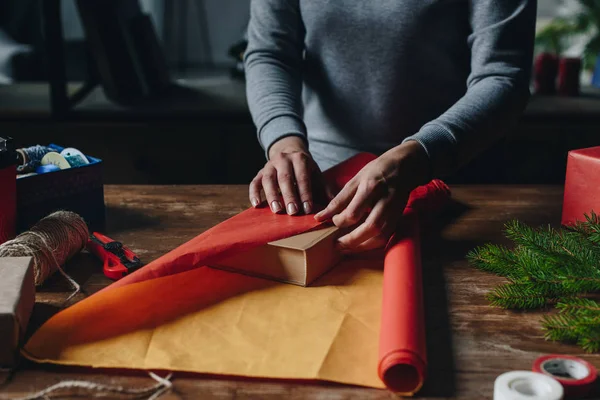 Woman wrapping book as christmas gift — Stock Photo, Image