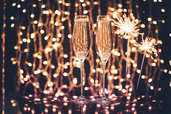 Glasses of champagne and sparklers — Stock Photo, Image