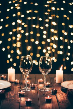wineglasses on table with candles clipart