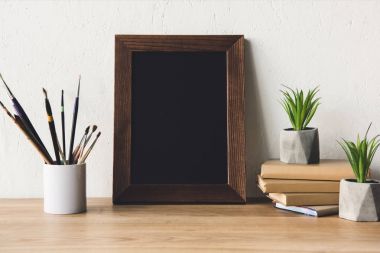 photo frame and book on tabletop clipart