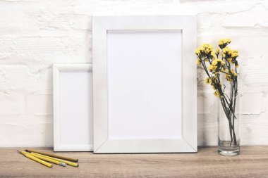 empty photo frames and flowers in vase clipart