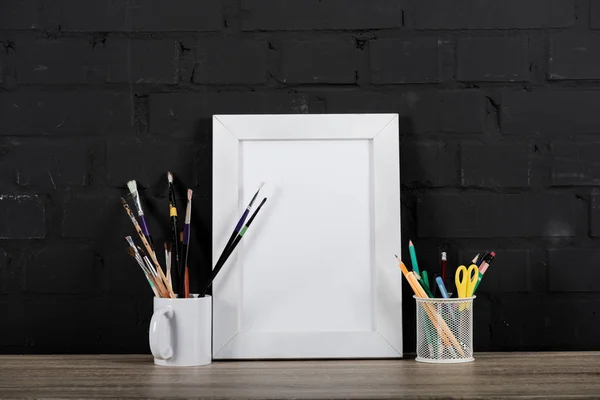 Photo frame and office supplies on table — Stock Photo, Image