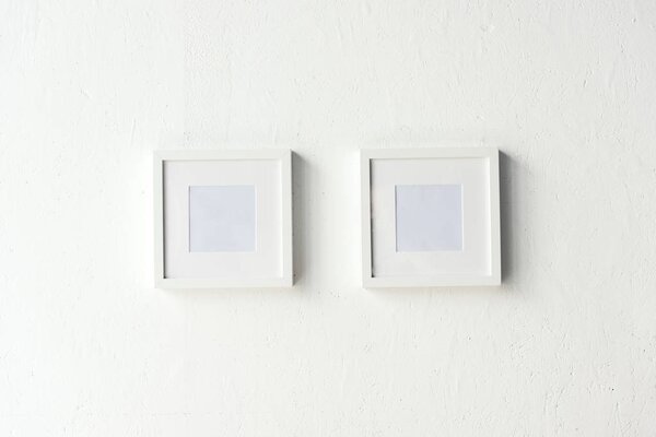 empty photo frames hanging on wall