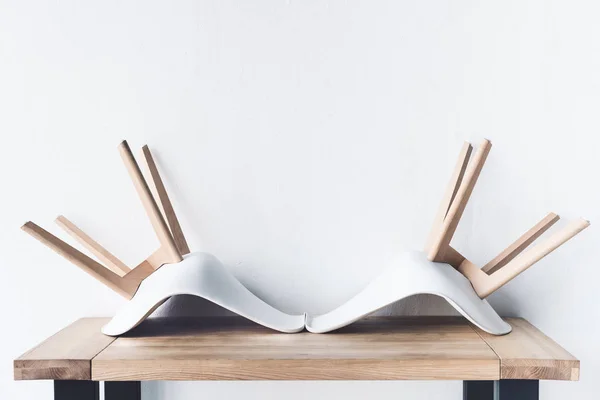 Chairs on wooden tabletop