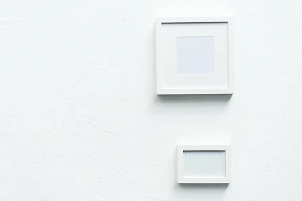 Empty photo frames hanging on wall — Stock Photo, Image