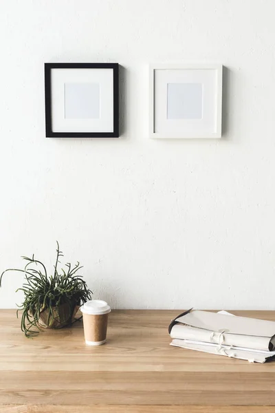 Photo frames hanging on wall in room — Stock Photo, Image
