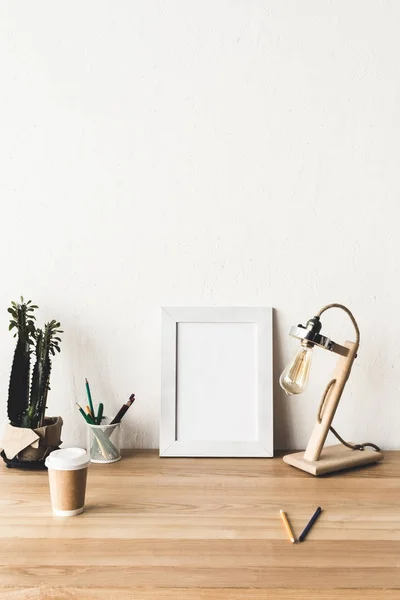 Photo frame and coffee to go on table — Stock Photo, Image