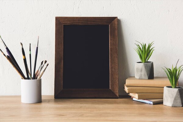 photo frame and book on tabletop