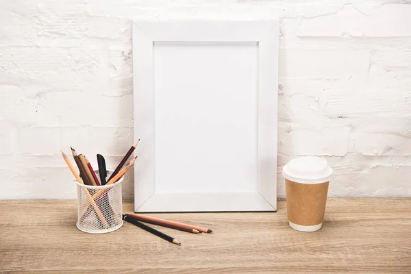 Photo frame and coffee to go on table — Stock Photo, Image
