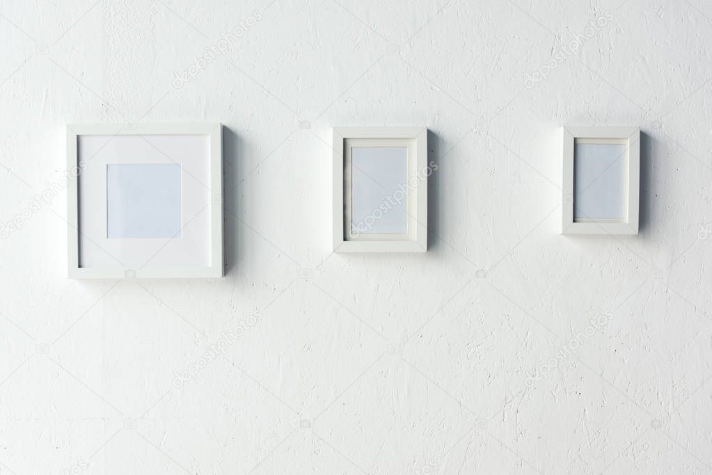 empty photo frames hanging on wall