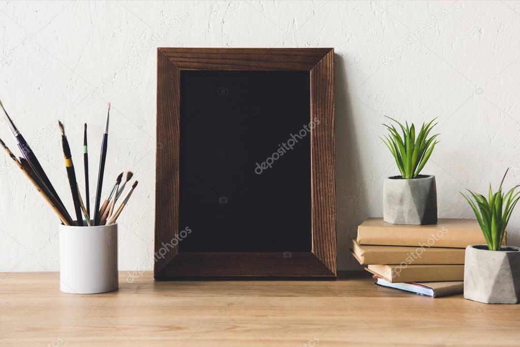 photo frame and book on tabletop