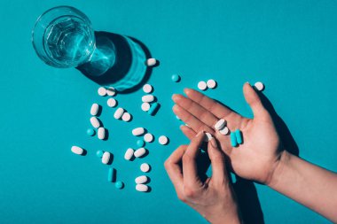 pills in hands and water in glass clipart