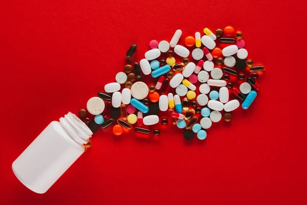 Colorful pills and container — Stock Photo, Image