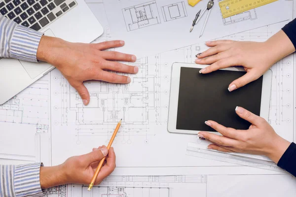 Architects at workplace with blueprints — Stock Photo, Image
