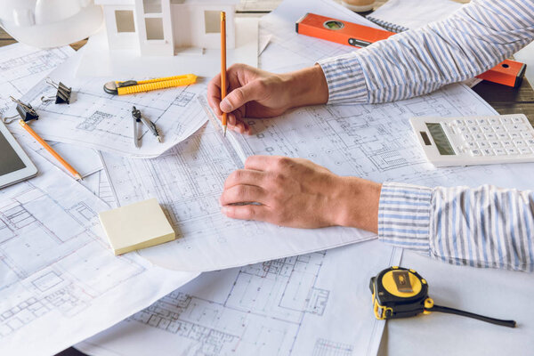 architect working with blueprints