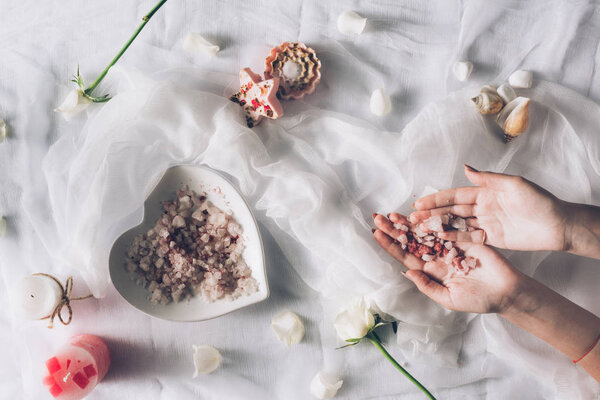 woman holding bathroom salt in hands