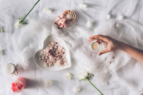 female hand holding small candle