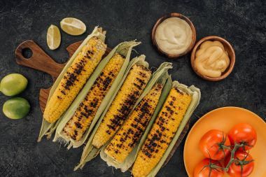 grilled corn covered in leaves clipart