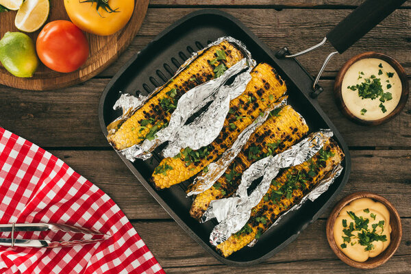 grilled corn on wooden table