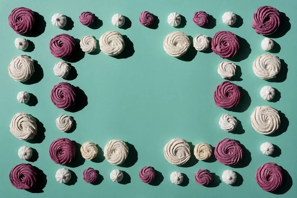Rahmen aus Marshmallows auf türkisfarbener Oberfläche — kostenloses Stockfoto